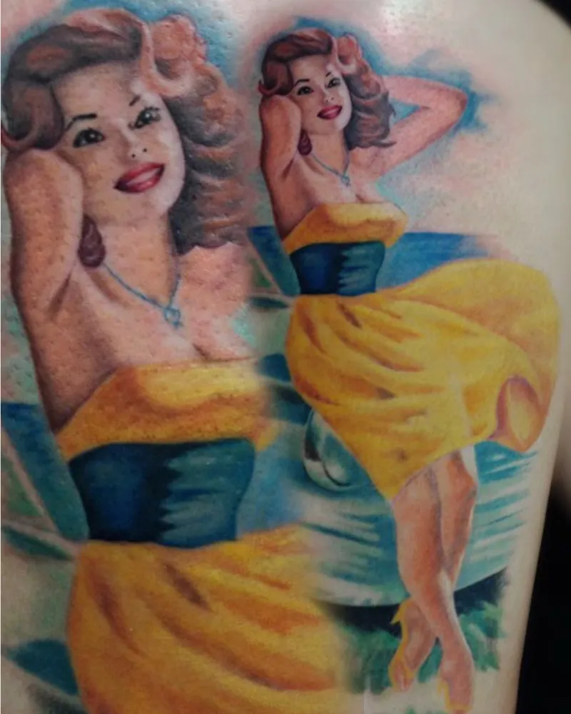 Color pin-up tattoo of a retro woman in a yellow dress posing on a beach, close-up and full view