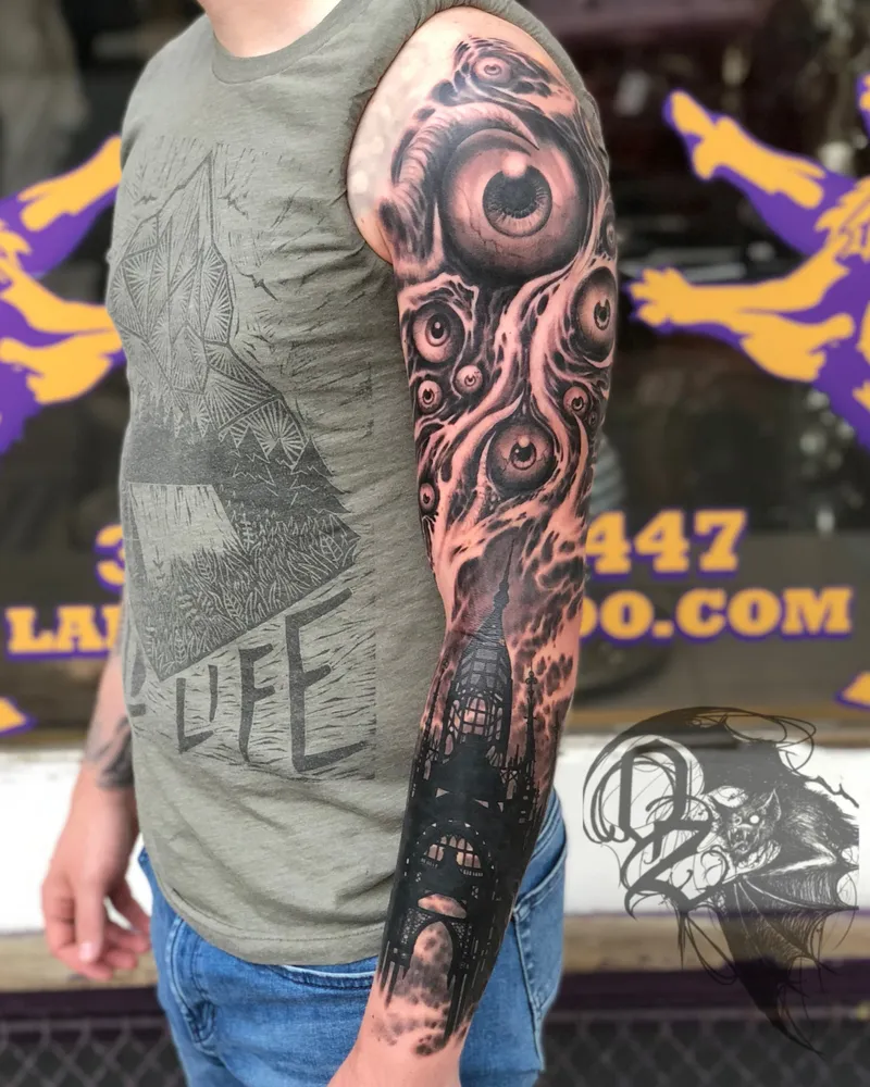 Bioorganic freehand full sleeve with clustered eyeballs flowing into a gothic cityscape