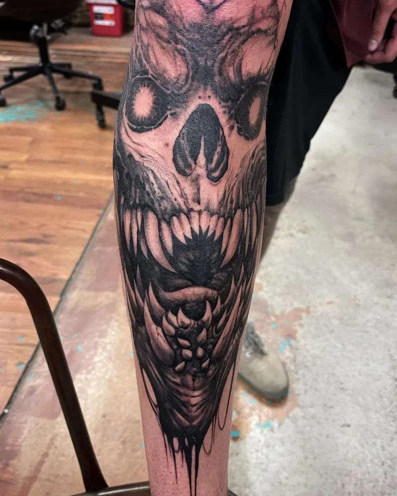 Freehand demon skull tattoo dripping down the forearm