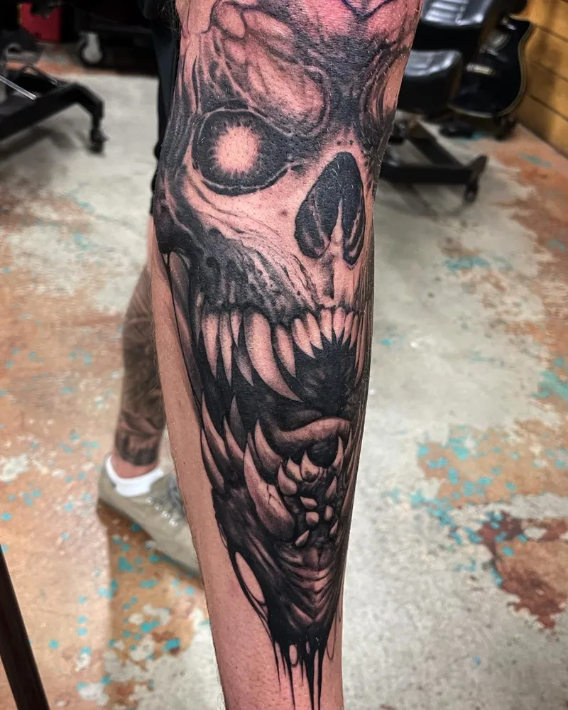 Freehand demon skull tattoo on the forearm, straight-on view